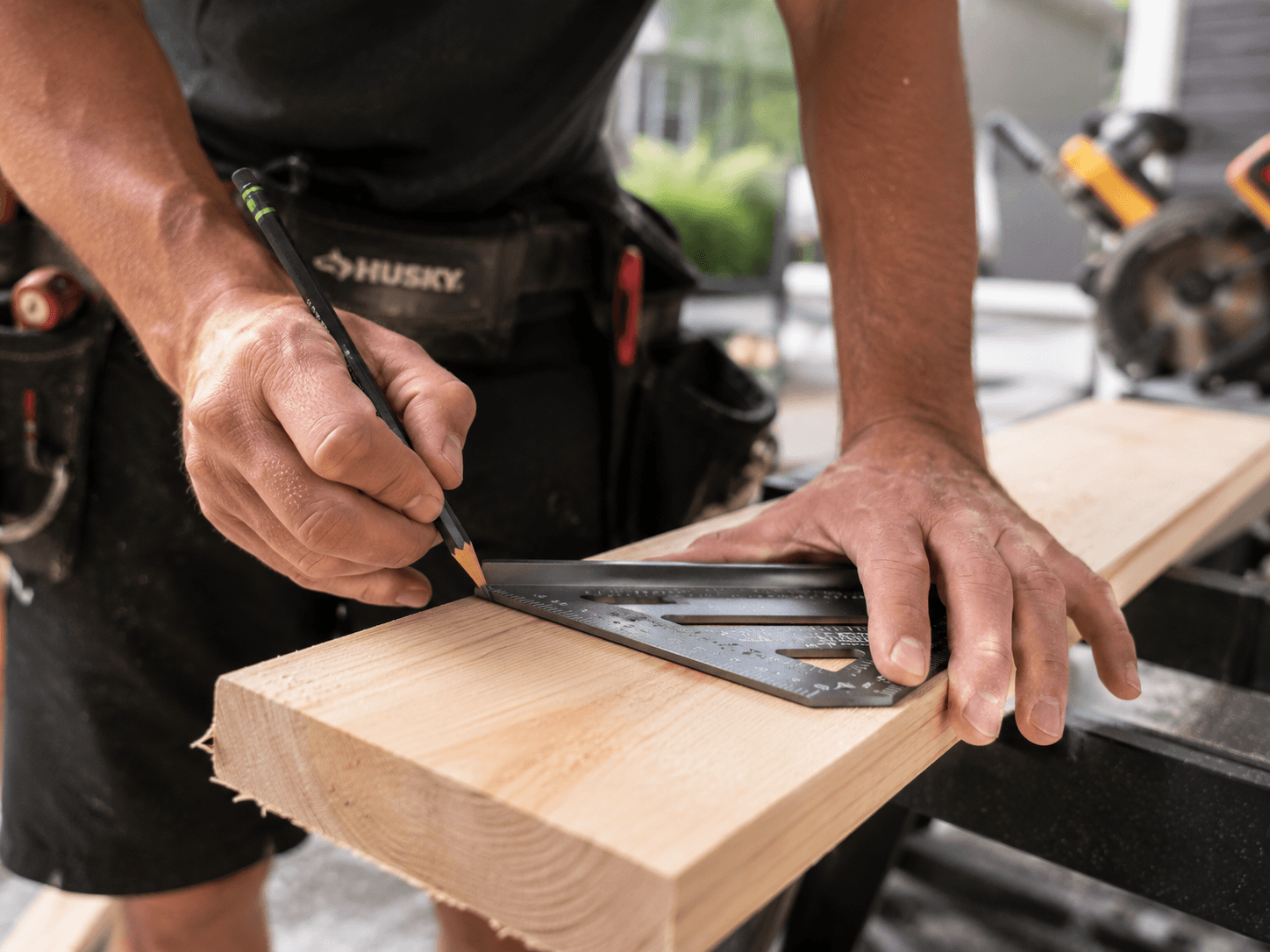 Carpenter measuring wood with precision outdoors