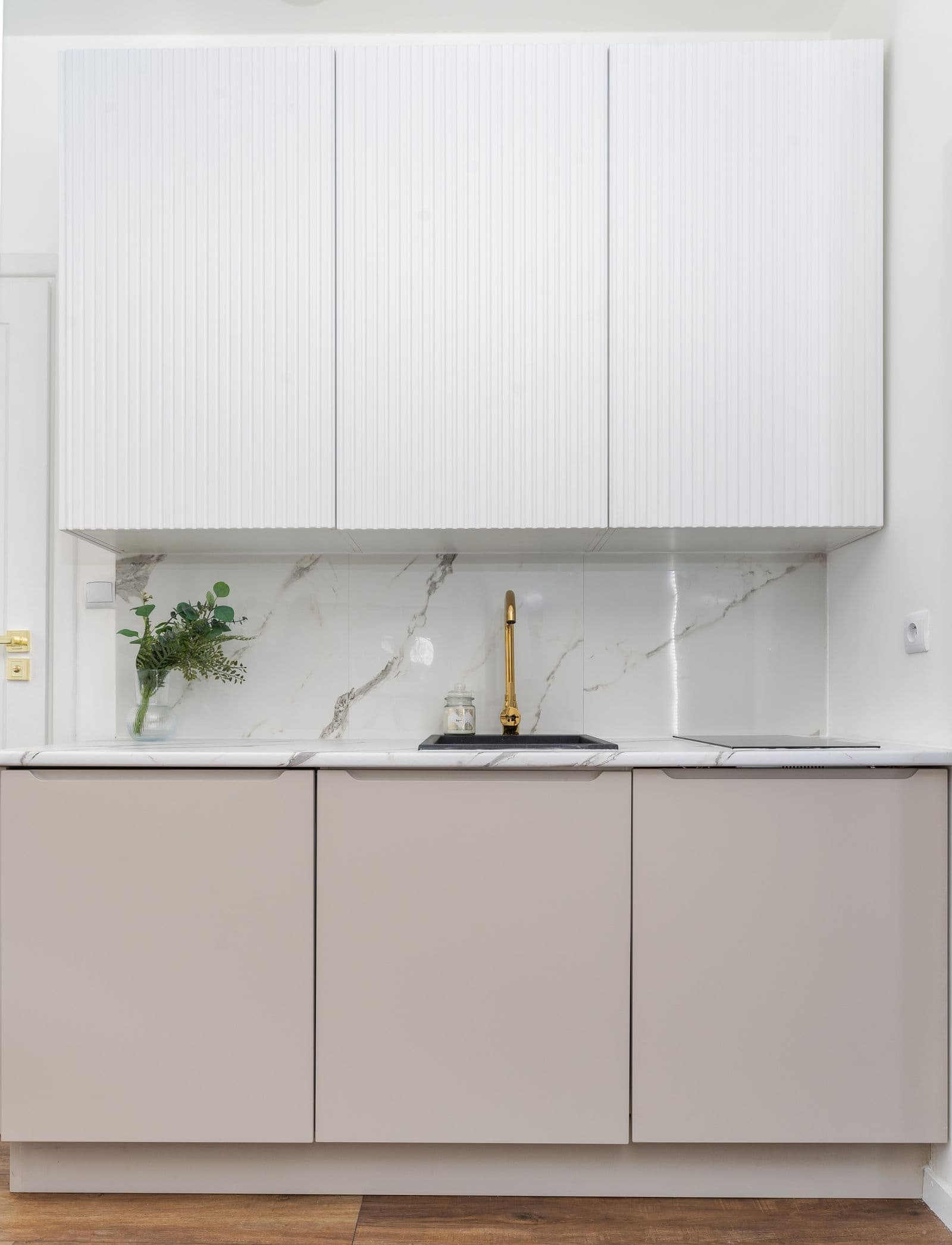Renovated luxury kitchen with marble backsplash and modern cabinetry